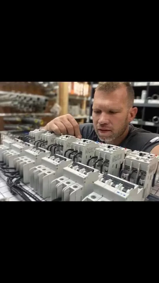 A&I technician assembling a detailed electrical control panel