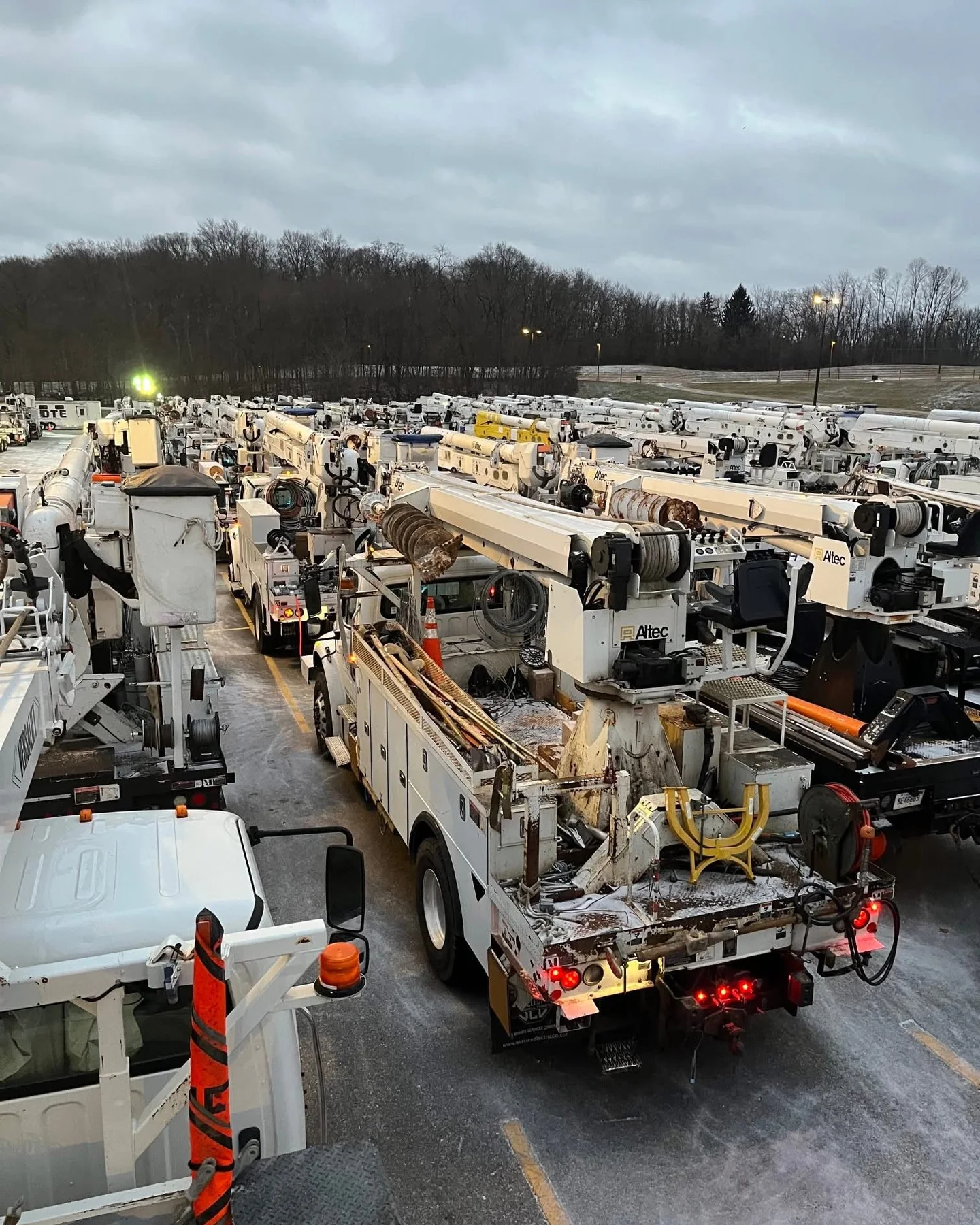 Utility bucket trucks staged for storm response